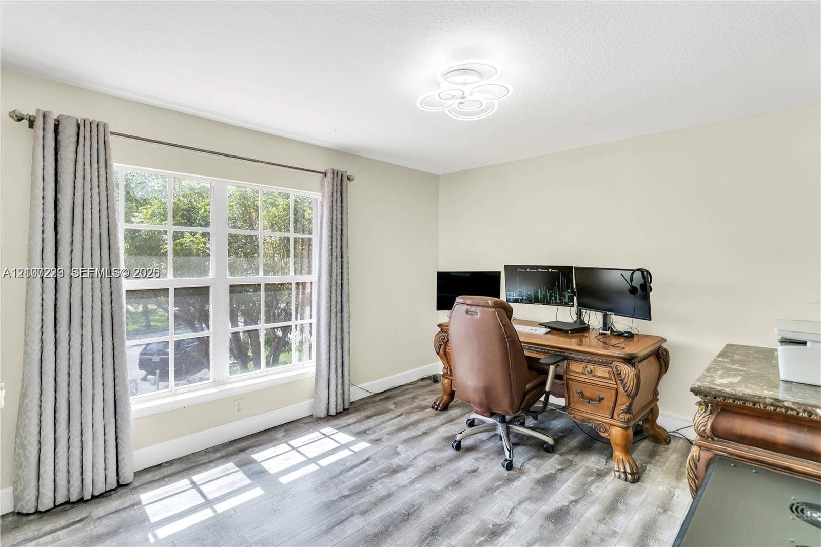5280 NW 95th Avenue, Coral Springs, Coral Springs, FL 33076 Multi-pane window, wood-finish flooring, and contemporary multi-ring flush mount lighting