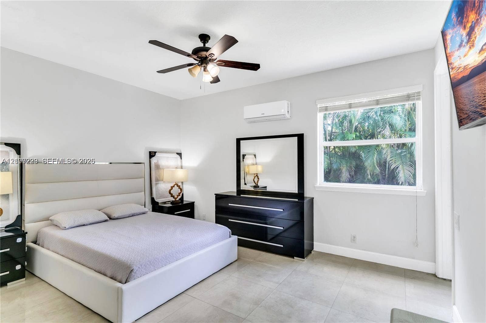 5280 NW 95th Avenue, Coral Springs, Coral Springs, FL 33076 Room featuring large-format tile flooring, a multi-blade ceiling fan with integrated lighting, and a wall-mounted ductless air conditioning unit