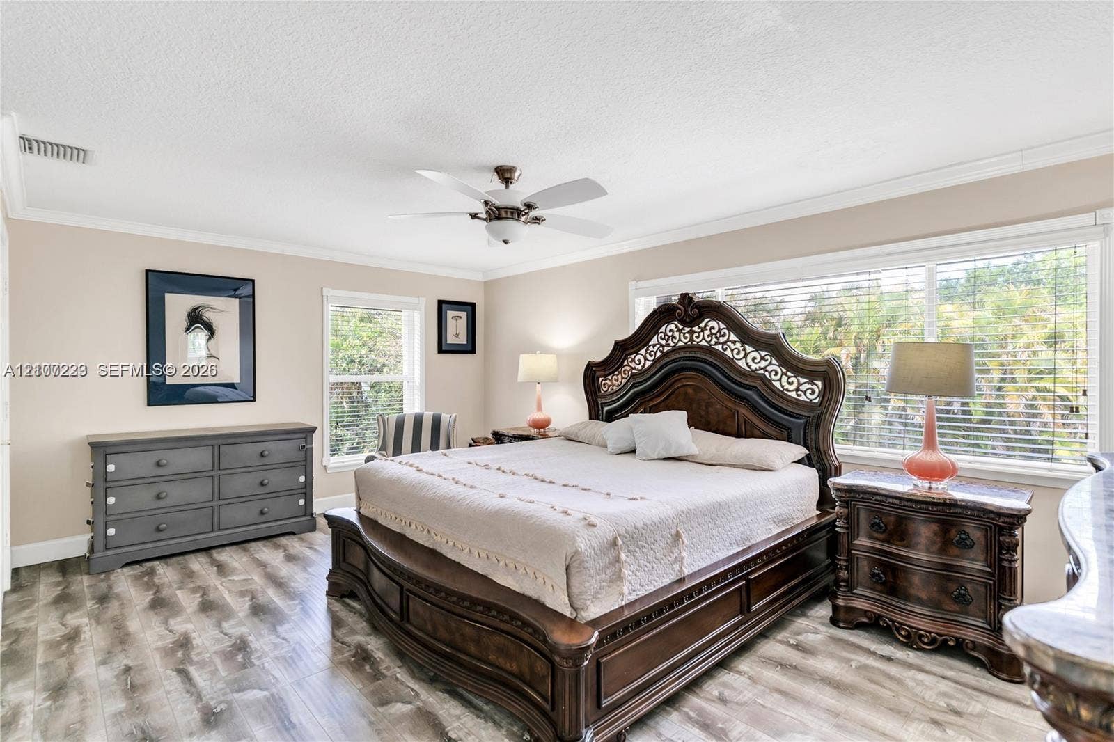 5280 NW 95th Avenue, Coral Springs, Coral Springs, FL 33076 Bedroom featuring wood-finish flooring, crown molding, a ceiling fan with integrated lighting, and large windows with horizontal blinds