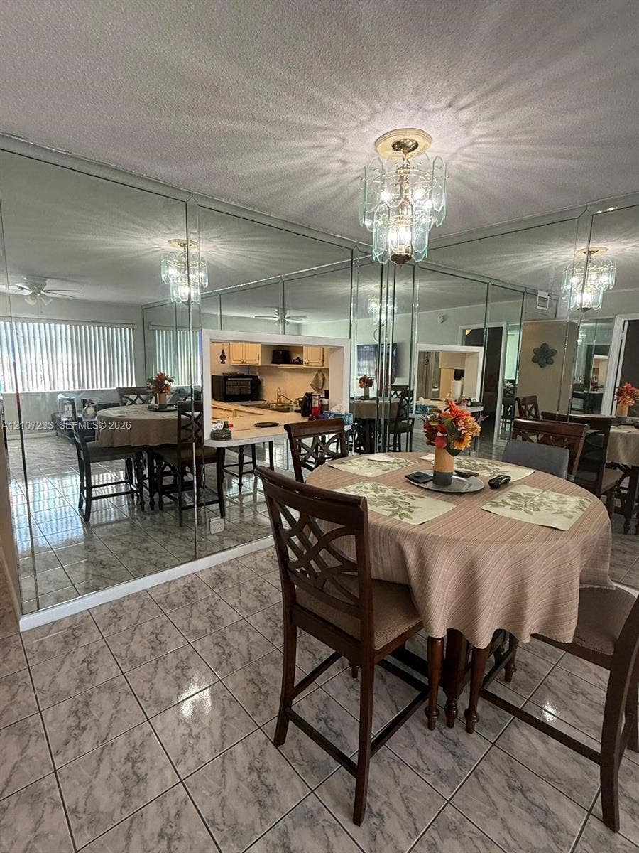 215 SE 3rd Avenue, #102D, Hallandale Beach, Hallandale Beach, FL 33009 Full-wall mirrored accent, decorative multi-tiered light fixture, and ceramic tile flooring