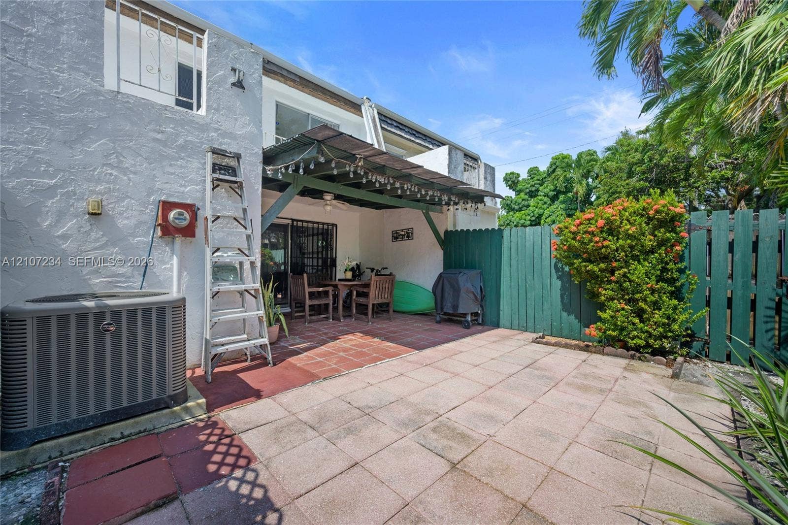 13507 NE 24th Court, North Miami, FL 33181 Private patio with concrete paver flooring, covered pergola, and privacy fencing