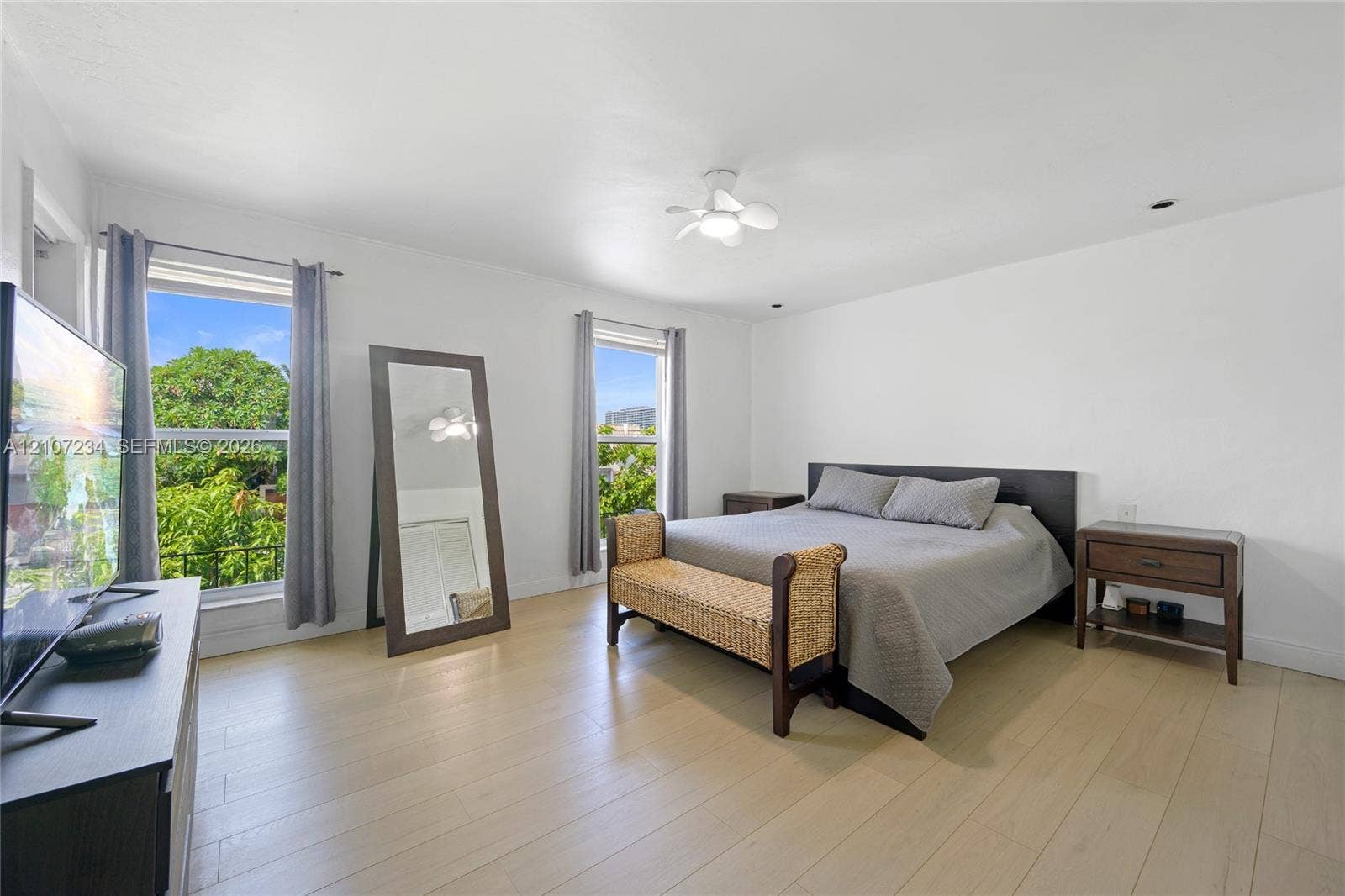 13507 NE 24th Court, North Miami, FL 33181 Neutral interior space featuring wood-finish flooring, dual windows, and a ceiling-mounted light fixture