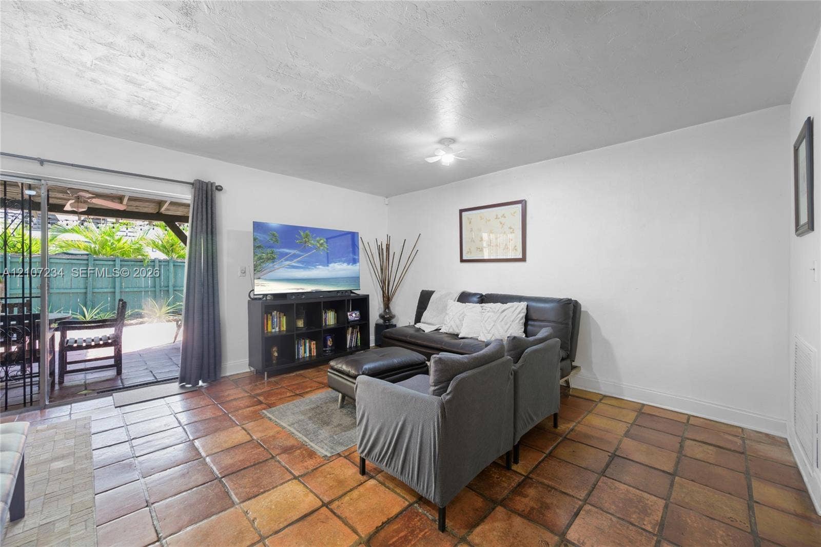 13507 NE 24th Court, North Miami, FL 33181 Ceramic tile flooring, sliding glass door, and white walls