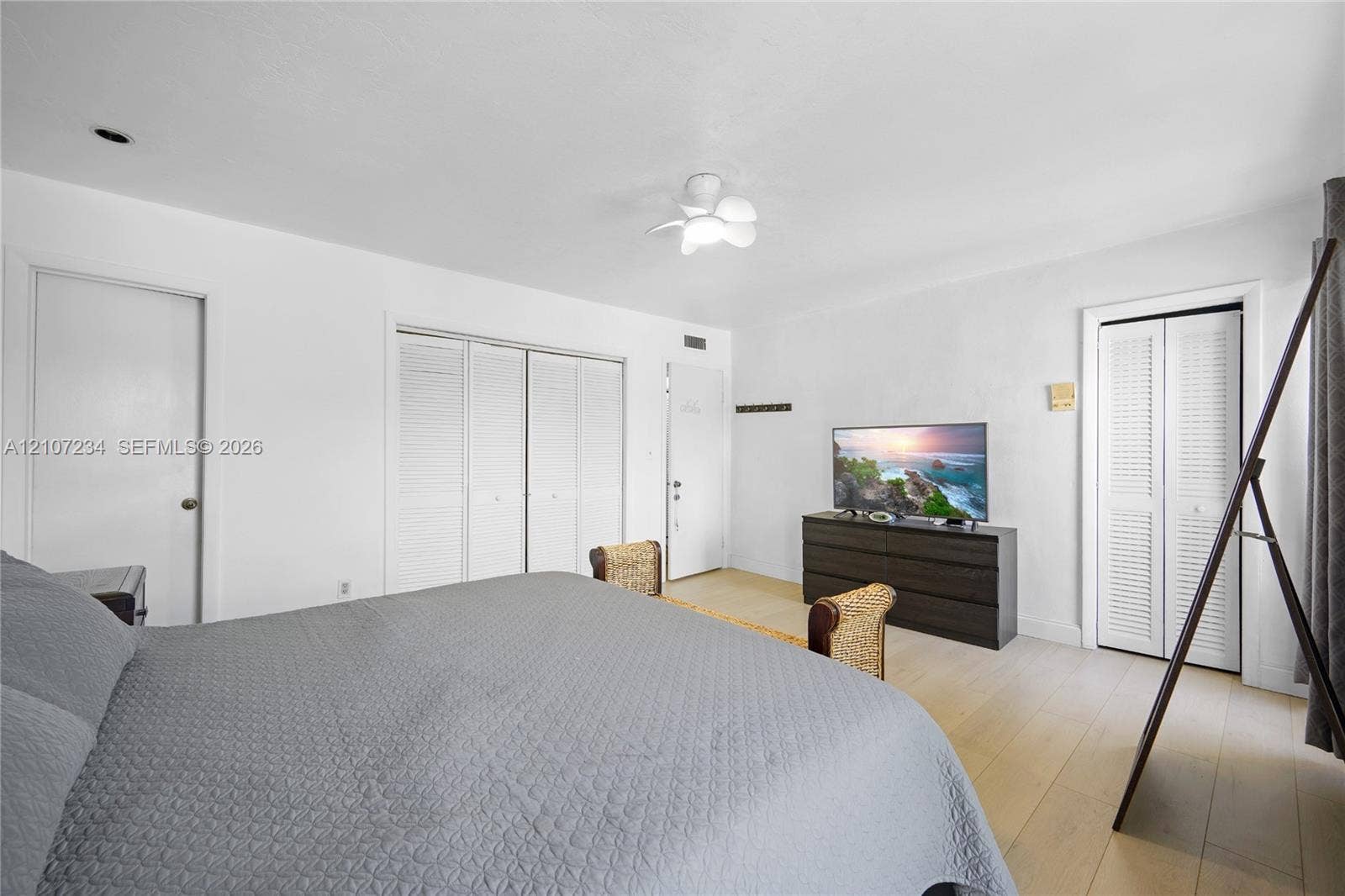 13507 NE 24th Court, North Miami, FL 33181 Light-toned wood-finish flooring, recessed ceiling lighting, a multi-light flush mount fixture, and double-door closets with louvered panels