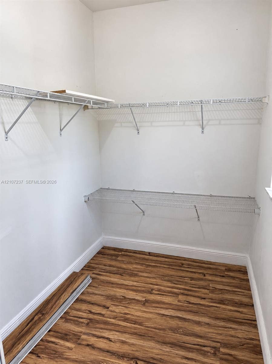 2529 NE 41st Terrace, Homestead, FL 33033 Storage area featuring wood-finish flooring and multi-level wall-mounted wire shelving