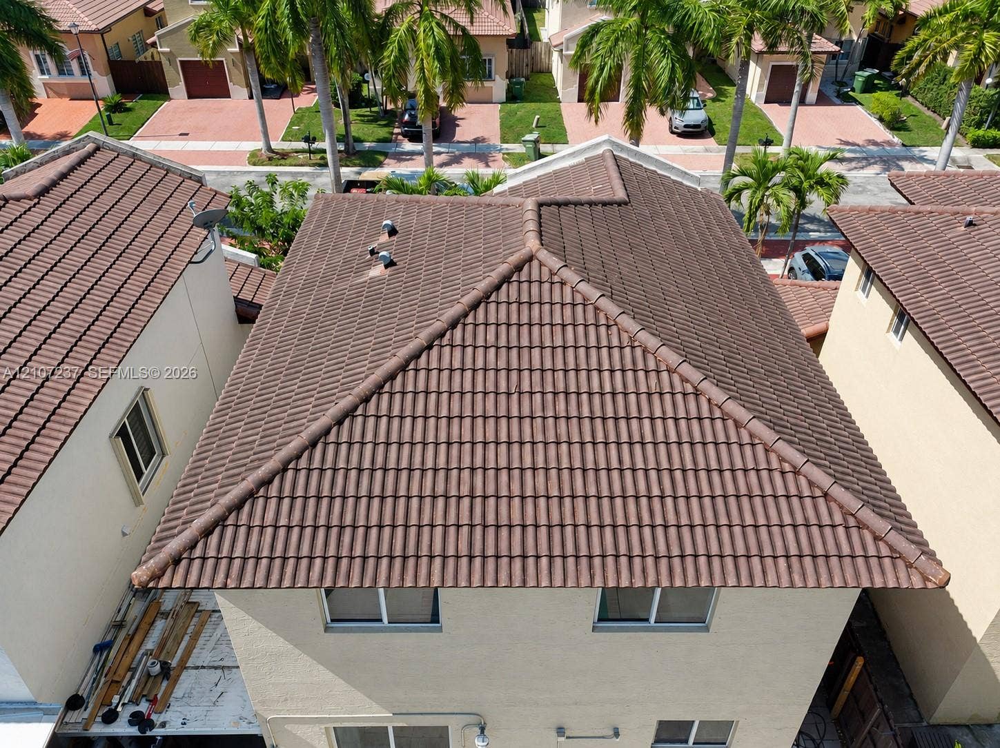 2529 NE 41st Terrace, Homestead, FL 33033 Multi-level residence featuring a hipped roof with textured tile finish and light-toned stucco exterior walls