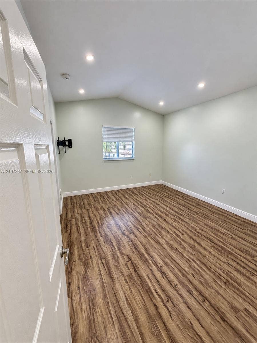 2529 NE 41st Terrace, Homestead, FL 33033 Vaulted ceilings featuring recessed lighting, wood-finish flooring, and a single window