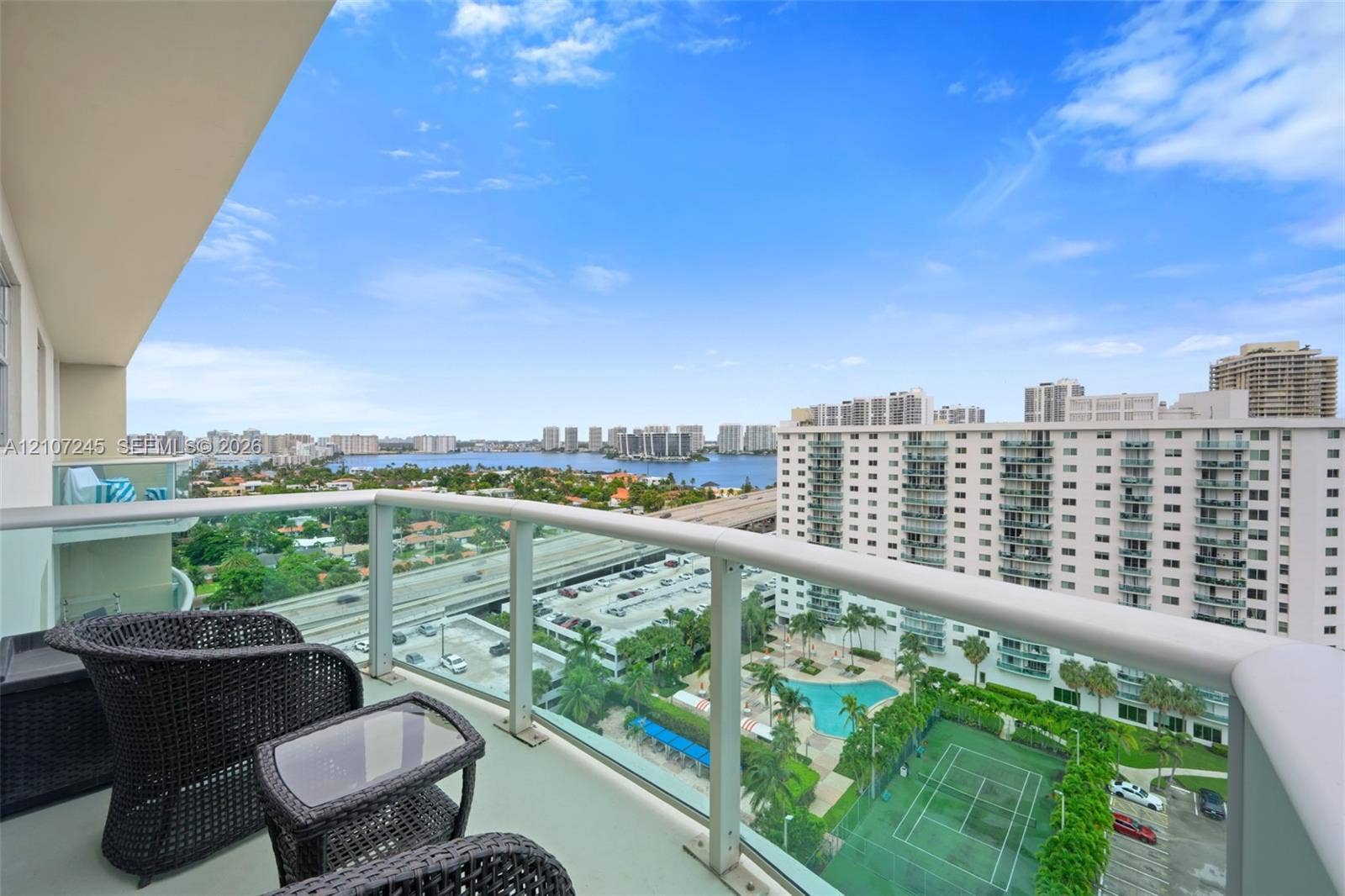 19370 Collins Avenue, #PH-14, Sunny Isles Beach, Sunny Isles Beach, FL 33160 Elevated balcony featuring glass railings and panoramic water and urban scenery