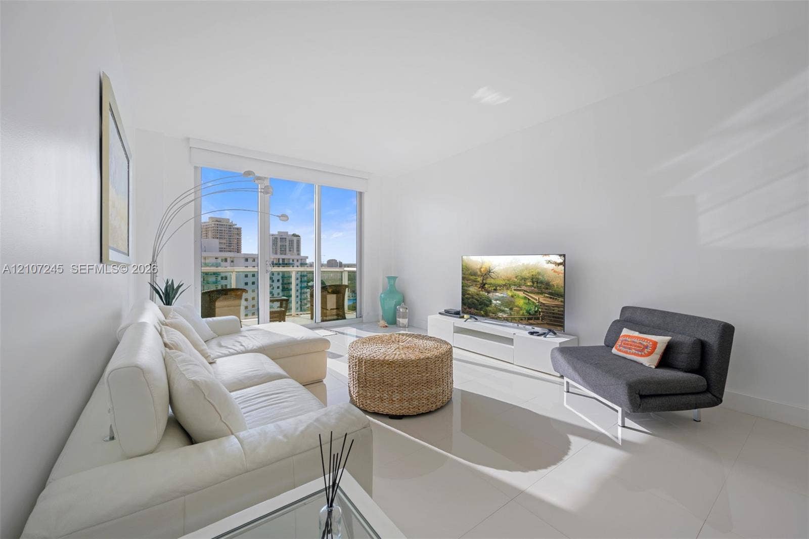 19370 Collins Avenue, #PH-14, Sunny Isles Beach, Sunny Isles Beach, FL 33160 Living area featuring polished tile flooring, neutral walls, and floor-to-ceiling glass sliding doors opening to a balcony