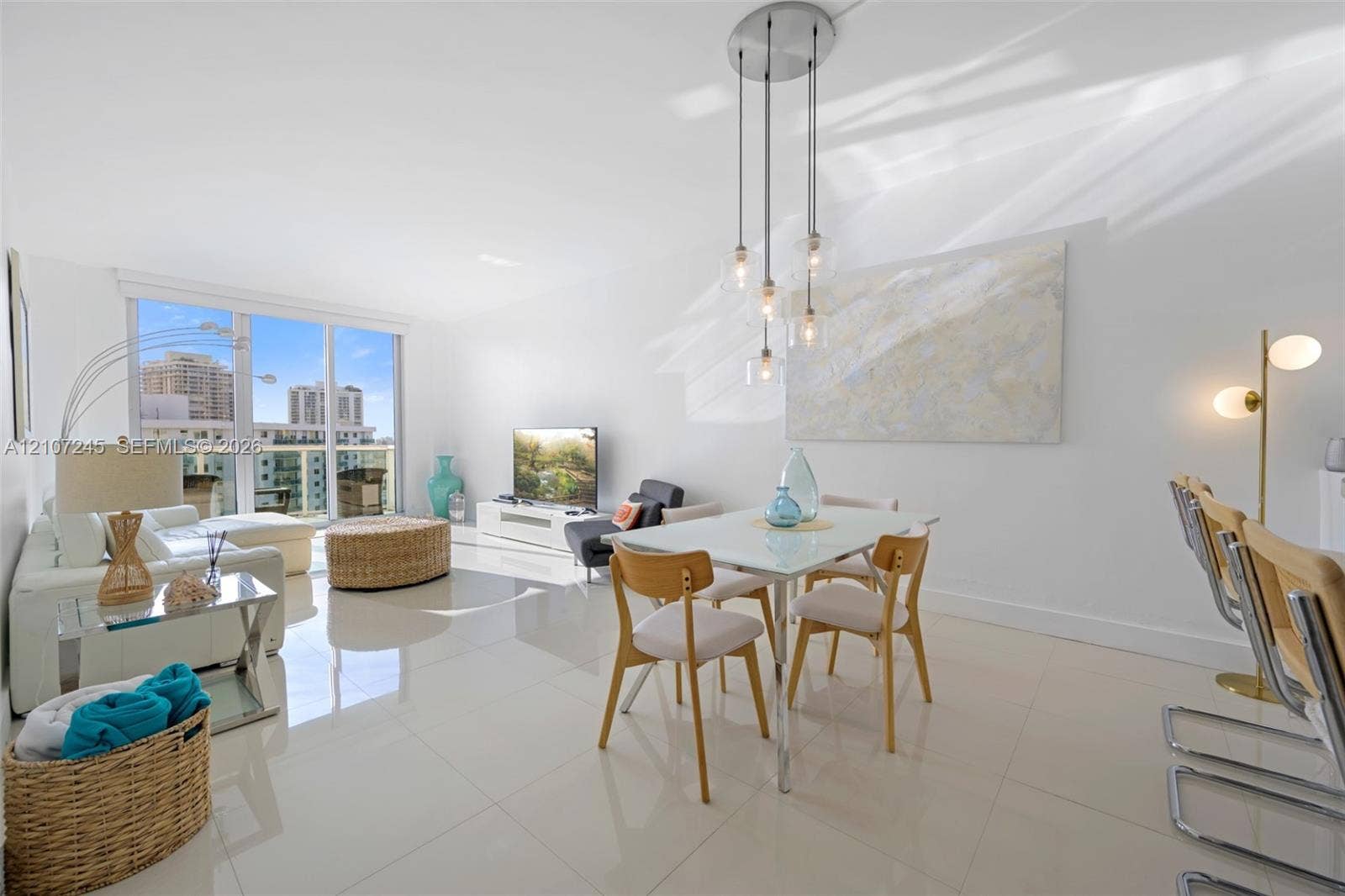 19370 Collins Avenue, #PH-14, Sunny Isles Beach, Sunny Isles Beach, FL 33160 Living area featuring polished tile flooring, floor-to-ceiling glass windows, and a multi-pendant light fixture