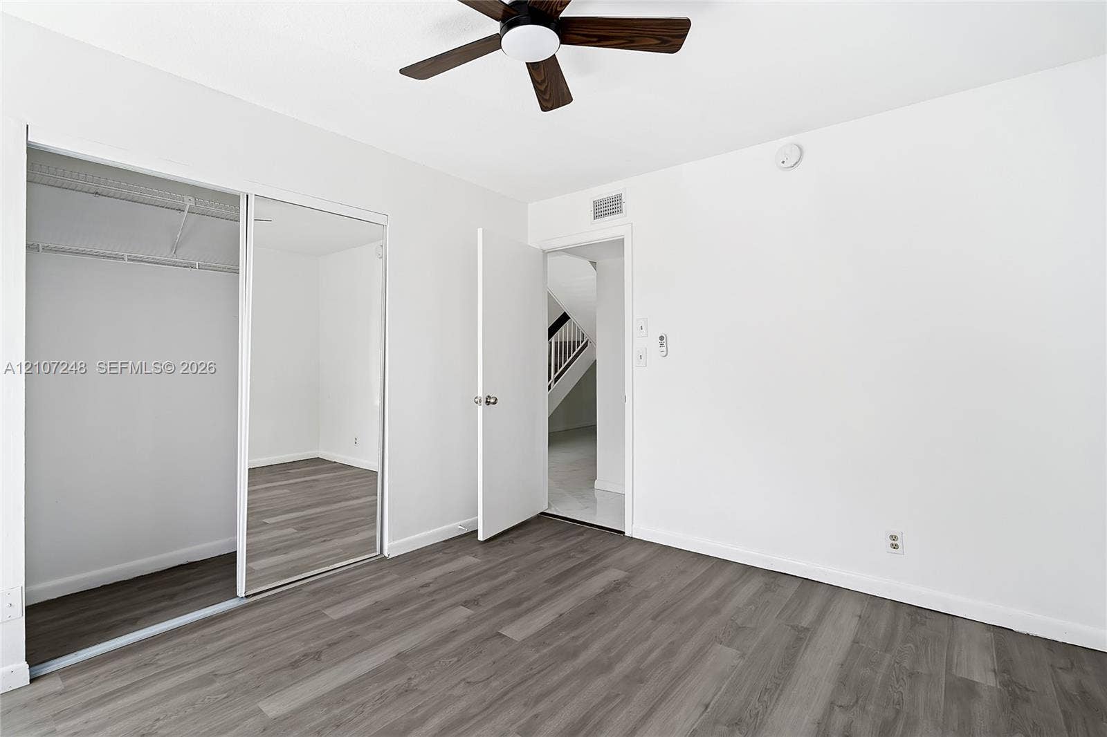 9983 W Atlantic Boulevard, #9983, Coral Springs, Coral Springs, FL 33071 Wood-finish flooring, mirrored sliding closet doors, and ceiling fan with integrated lighting