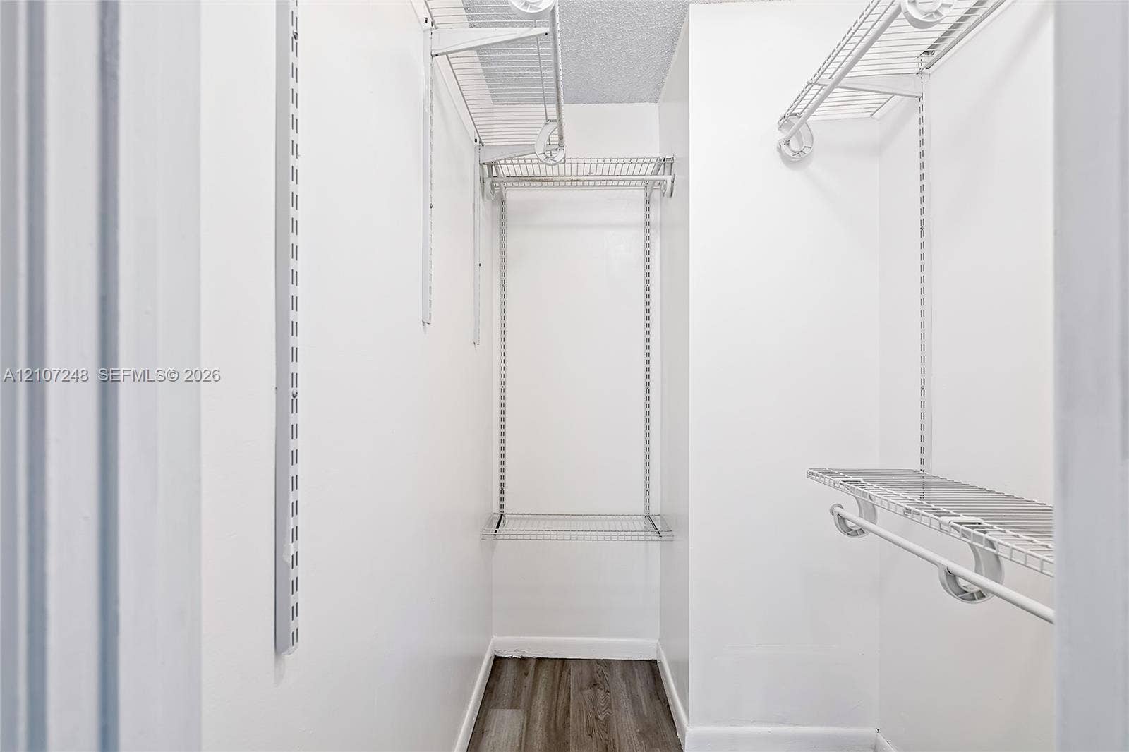 9983 W Atlantic Boulevard, #9983, Coral Springs, Coral Springs, FL 33071 Walk-in storage space featuring adjustable metal shelving units and wood-finish flooring