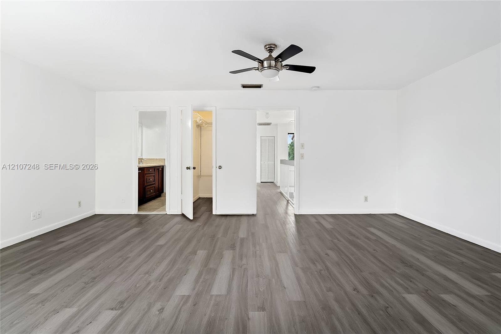 9983 W Atlantic Boulevard, #9983, Coral Springs, Coral Springs, FL 33071 Wood-finish flooring, ceiling fan with integrated lighting, and multiple interior doorways providing access to built-in closet space and additional rooms