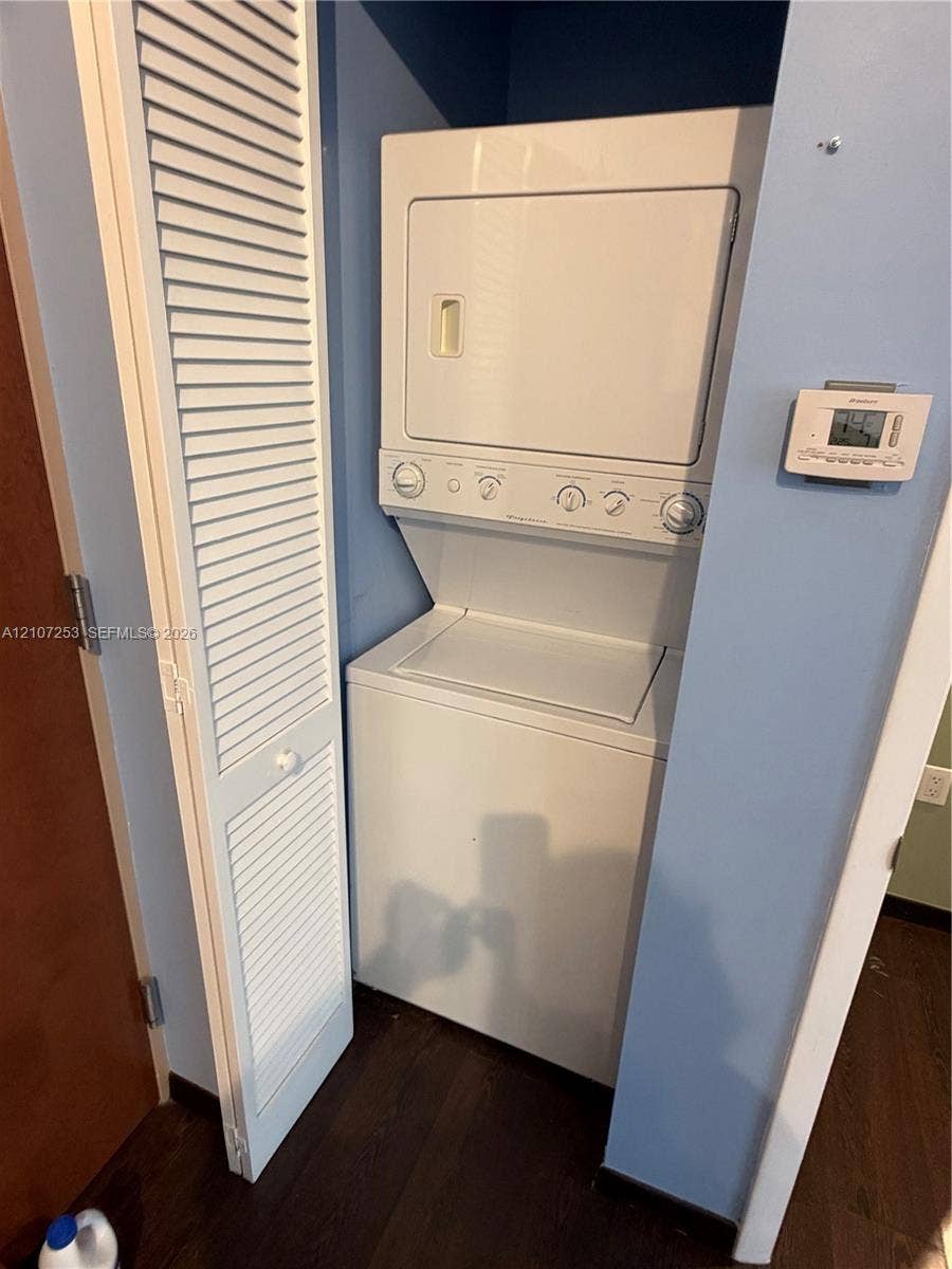 435 21st Street, #316, Miami Beach, Miami Beach, FL 33139 Stackable laundry unit with white finish, louvered bi-fold closet door, and digital wall-mounted thermostat