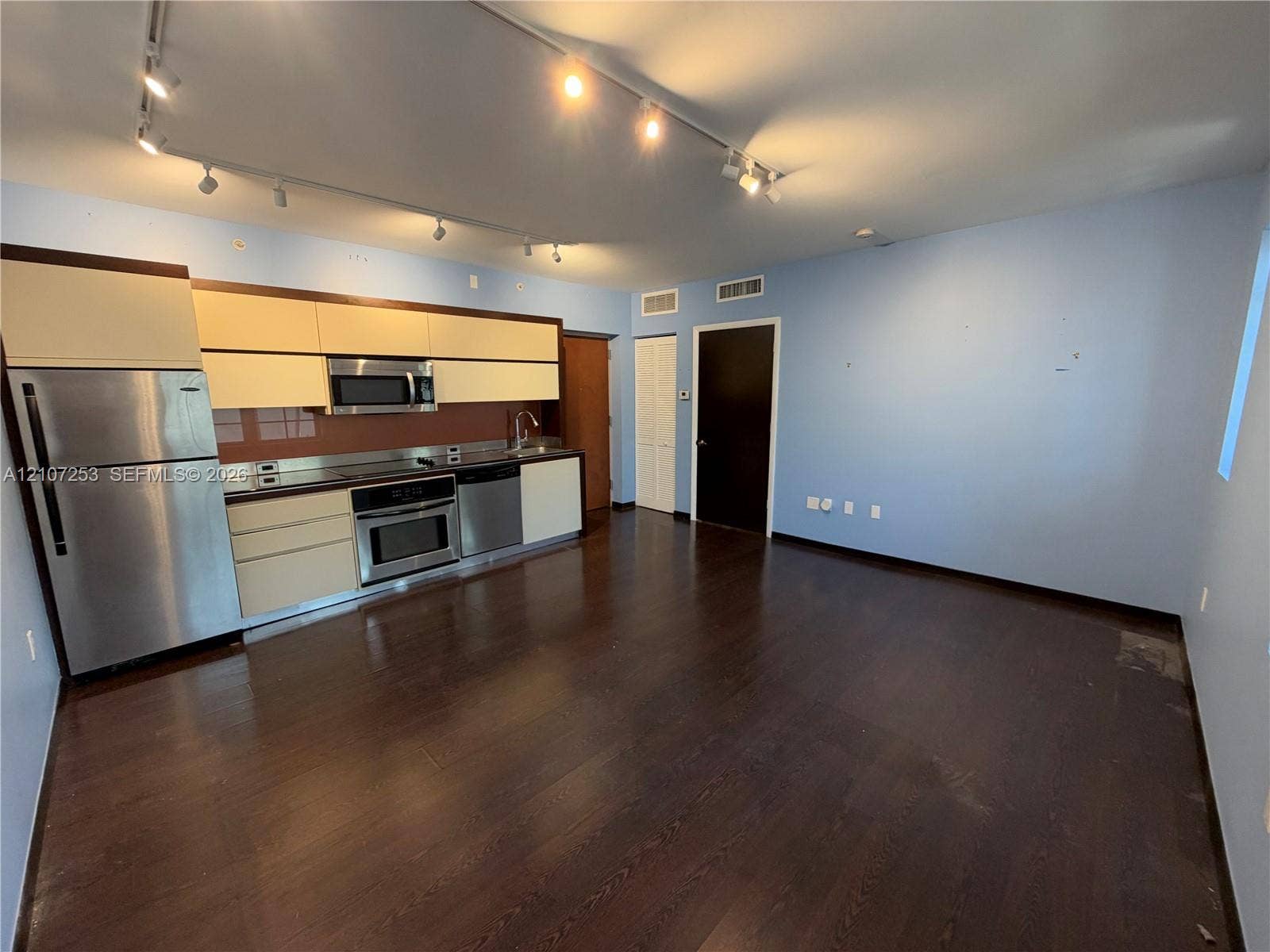435 21st Street, #316, Miami Beach, Miami Beach, FL 33139 Kitchen featuring flat-panel cabinetry, stainless steel appliances, wood-finish flooring, and multi-point ceiling track lighting