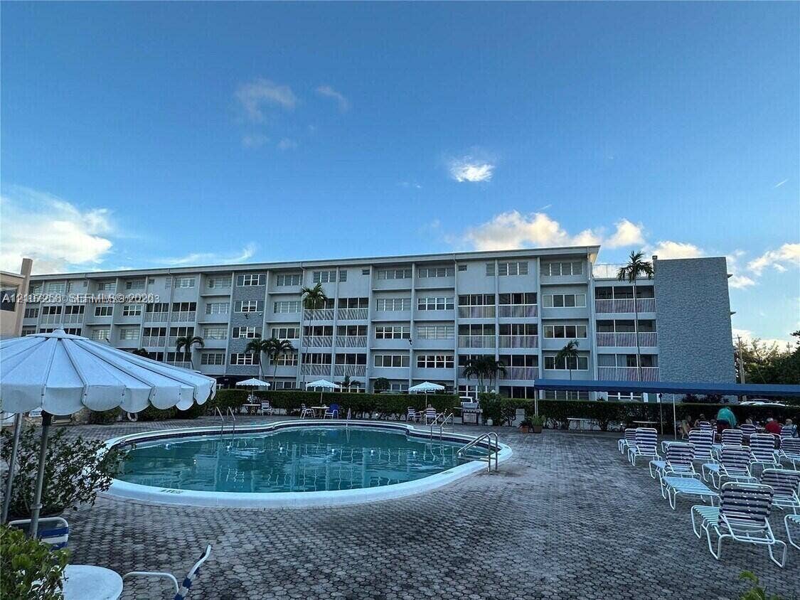 215 SE 3rd Avenue, #102D, Hallandale Beach, FL 33009 Community swimming pool with concrete paver decking and integrated metal handrails