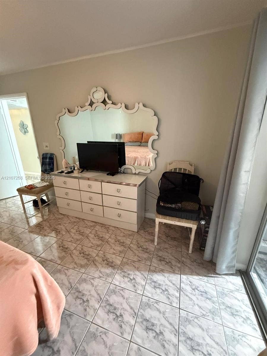 215 SE 3rd Avenue, #102D, Hallandale Beach, FL 33009 Tiled flooring throughout with sliding mirrored closet doors and built-in closet shelving