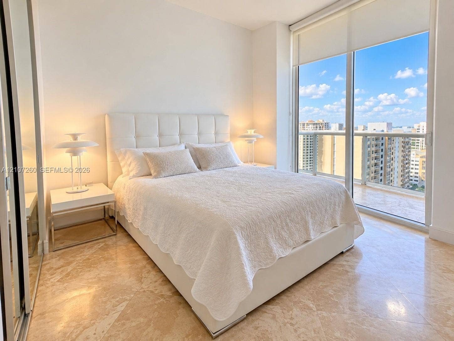 16001 Collins Avenue, #1605, Sunny Isles Beach, FL 33160 Floor-to-ceiling sliding glass doors, polished stone flooring, and mirrored closet doors