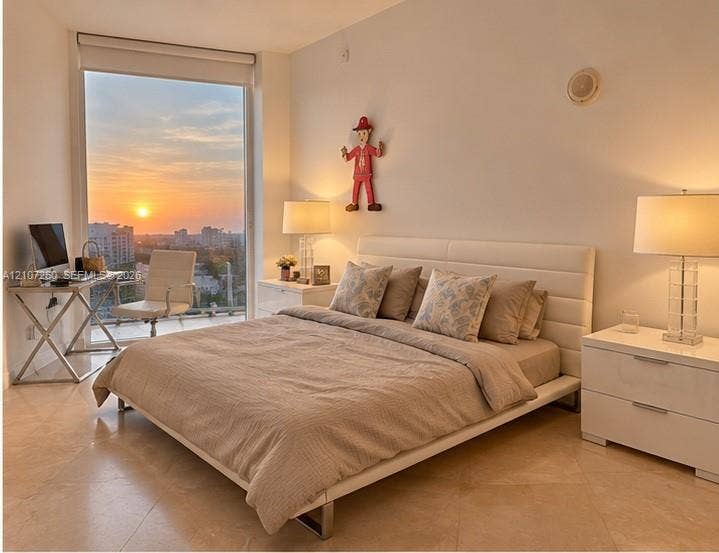 16001 Collins Avenue, #1605, Sunny Isles Beach, FL 33160 Floor-to-ceiling window featuring a sunset backdrop, polished tile flooring, and integrated ceiling speaker