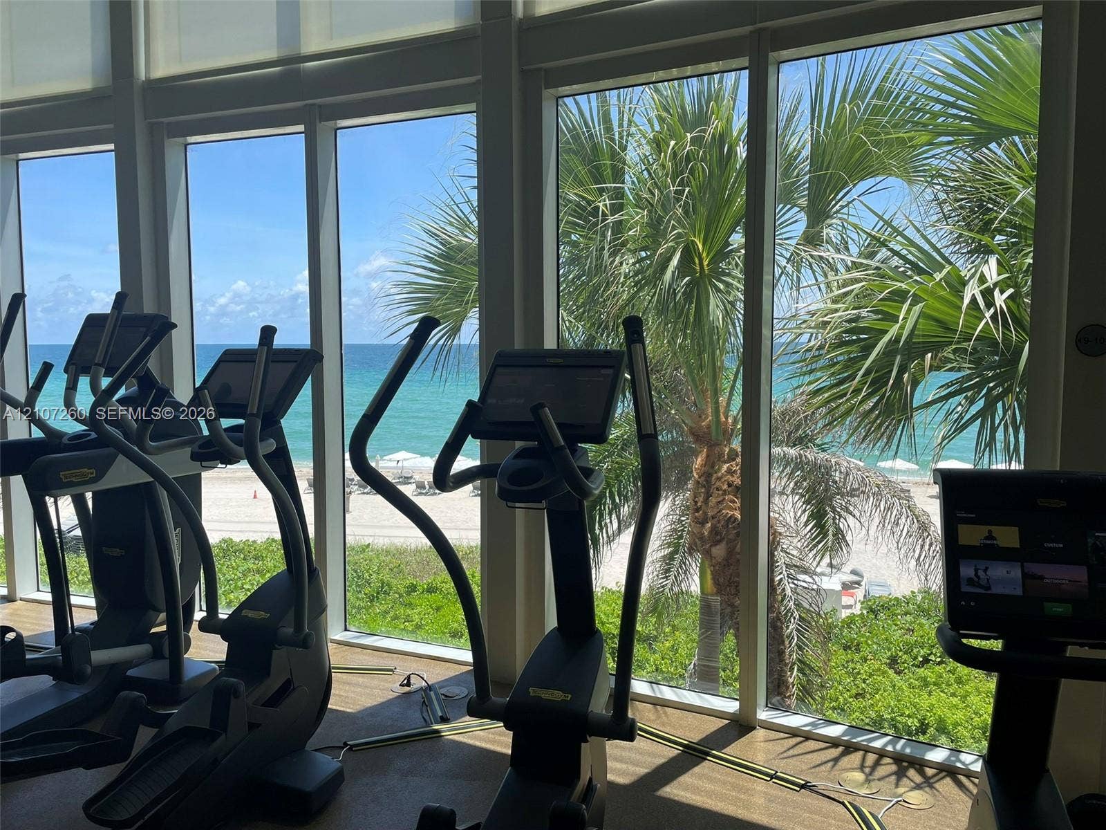 16001 Collins Avenue, #1605, Sunny Isles Beach, FL 33160 Floor-to-ceiling windows featuring ocean and beach scenery, integrated roller shades, and textured flooring