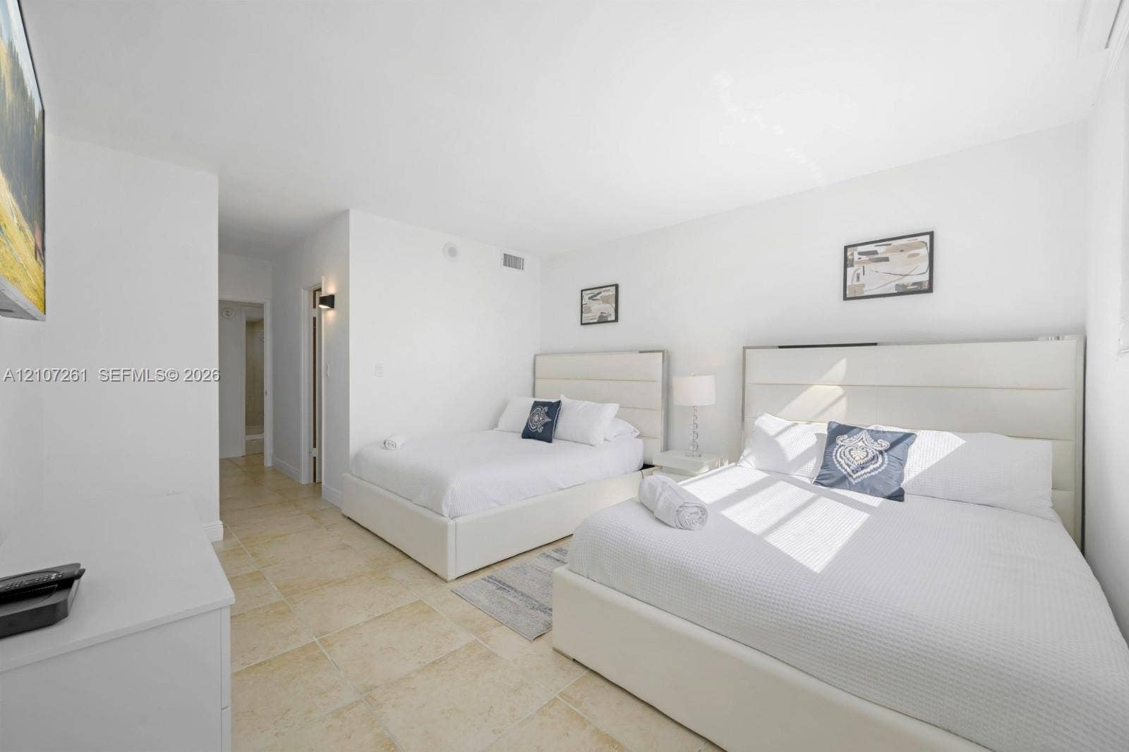 19370 Collins Avenue, #1601, Sunny Isles Beach, Sunny Isles Beach, FL 33160 Neutral-toned stone flooring and wall-mounted lighting fixture