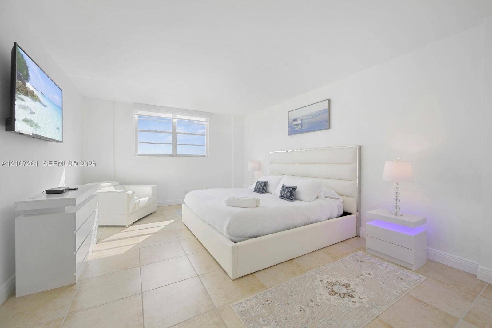 19370 Collins Avenue, #1601, Sunny Isles Beach, Sunny Isles Beach, FL 33160 Neutral-toned tile flooring, minimalist white walls, and a multi-pane window