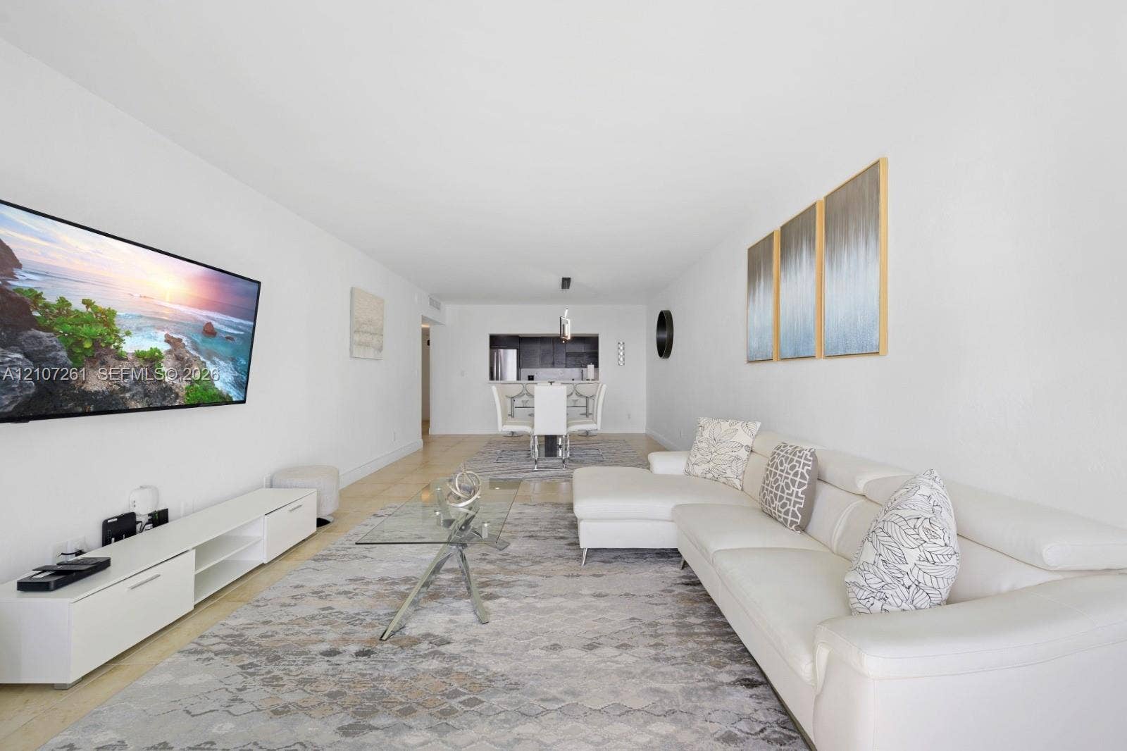 19370 Collins Avenue, #1601, Sunny Isles Beach, Sunny Isles Beach, FL 33160 Open-concept interior featuring neutral wall tones, large-format tile flooring, and a kitchen pass-through window