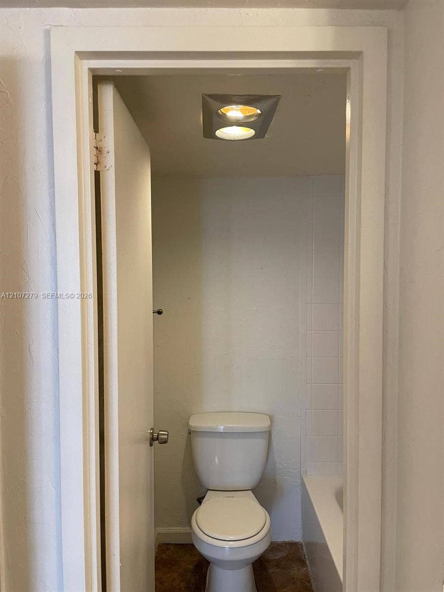 20100 W Country Club Drive, #601, Aventura, FL 33180 White porcelain commode and recessed ceiling lighting featuring a square-frame fixture