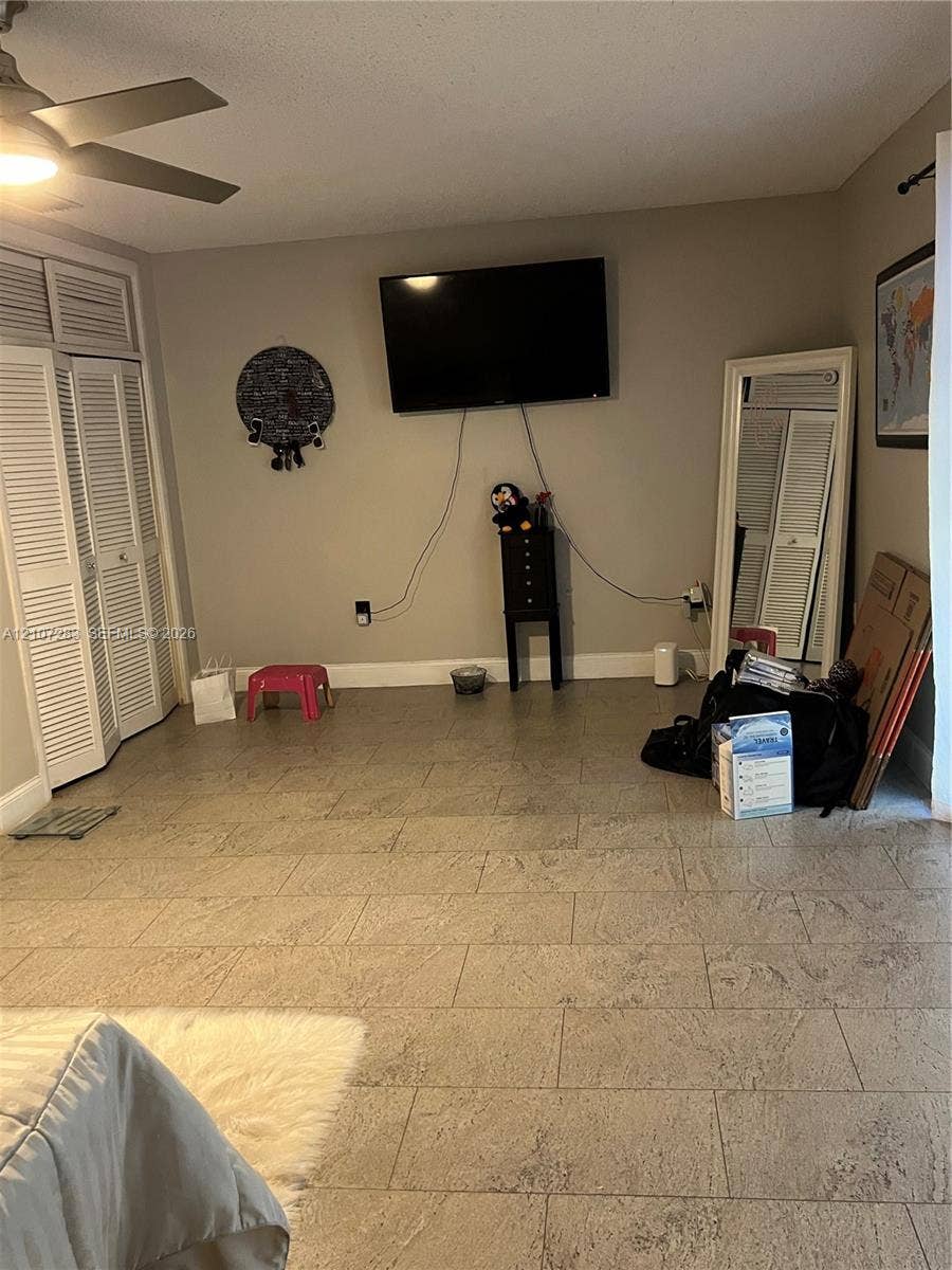 3301 Raleigh Street, #4E, Hollywood, FL 33021 Tile flooring, ceiling fan, and louvered closet doors