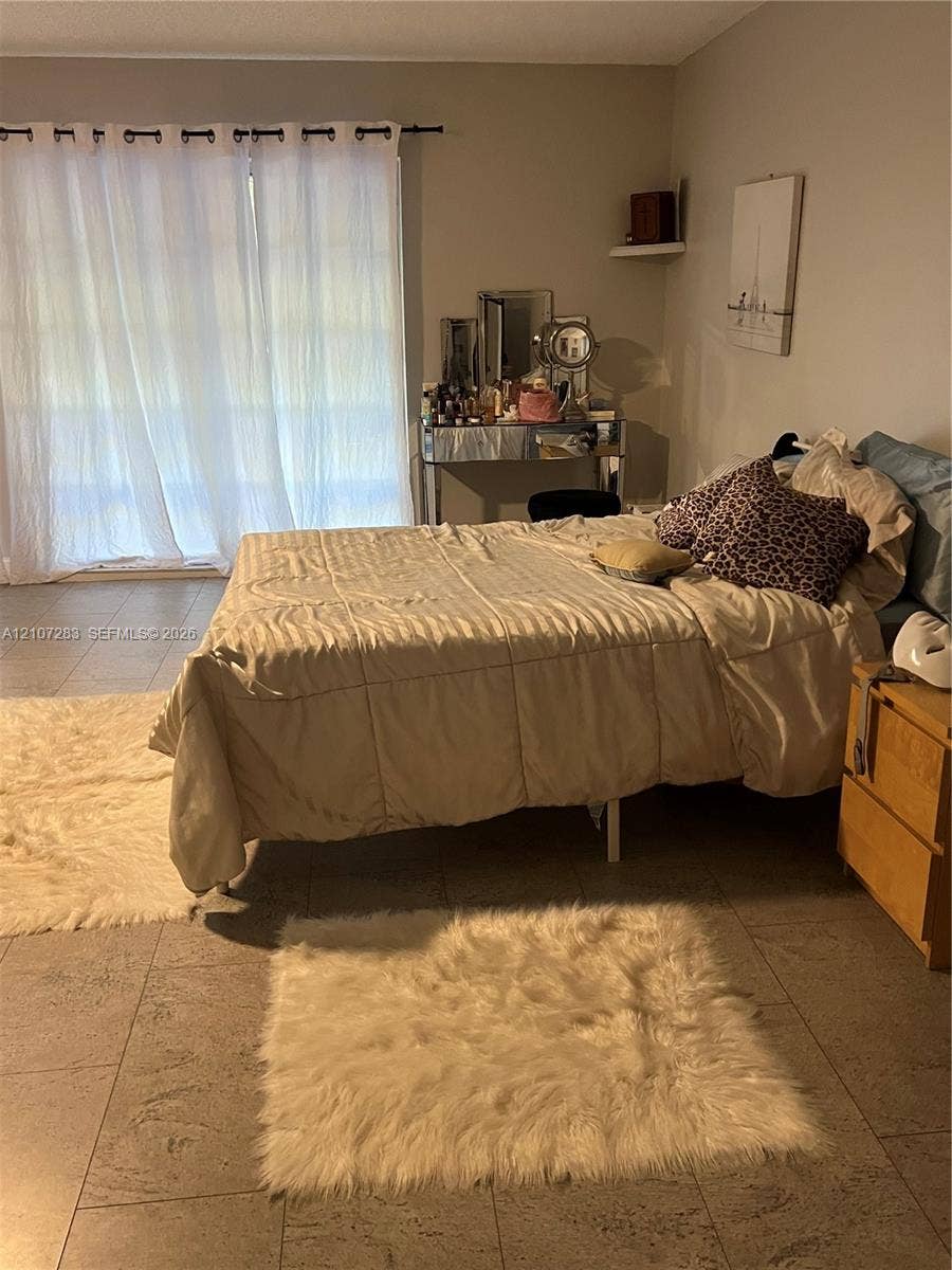 3301 Raleigh Street, #4E, Hollywood, FL 33021 Large-format neutral tile flooring and sliding glass door with integrated drapery rod
