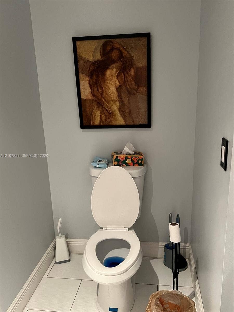 3301 Raleigh Street, #4E, Hollywood, FL 33021 Ceramic tile flooring and white porcelain toilet