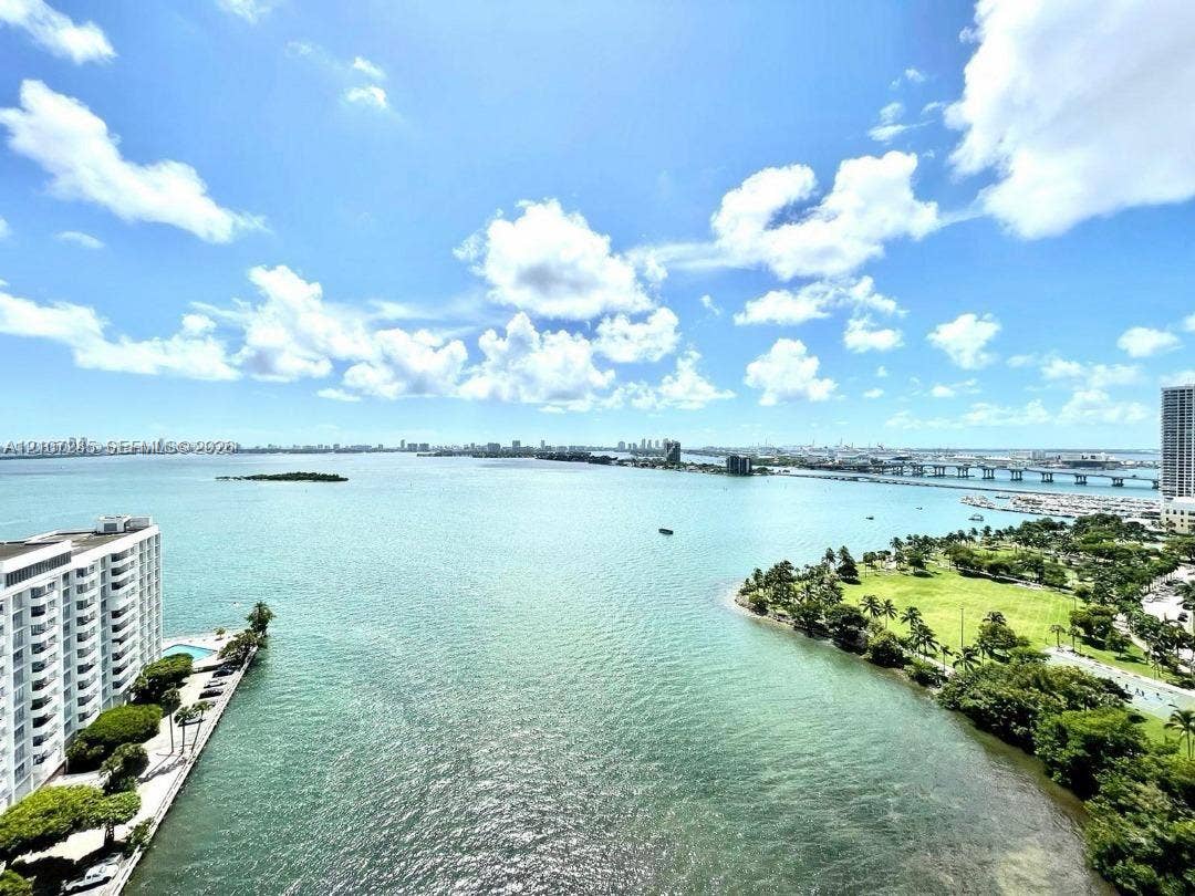 2020 N Bayshore Drive, #2102, Miami, FL 33137 Expansive water expanse featuring a shoreline park, tropical vegetation, and bridge infrastructure