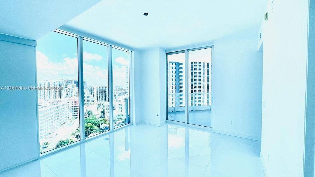 2020 N Bayshore Drive, #2102, Miami, FL 33137 Floor-to-ceiling windows, white tile flooring, and sliding glass doors with direct exterior access