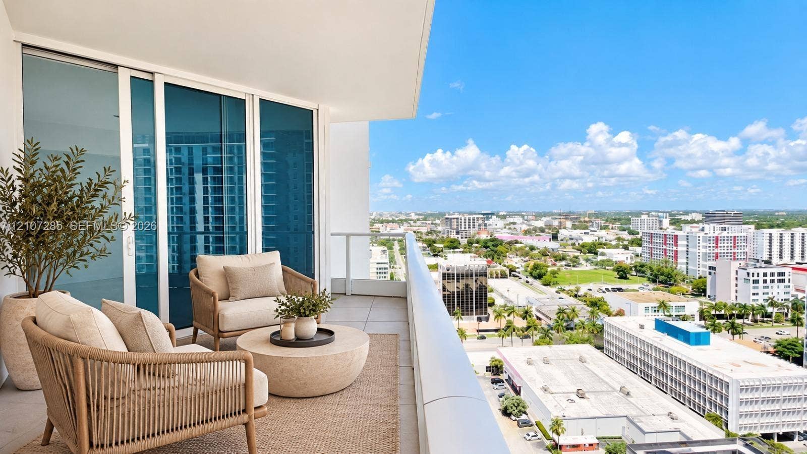2020 N Bayshore Drive, #2102, Miami, FL 33137 Private balcony featuring oversized tile flooring, glass panel railings, and floor-to-ceiling sliding glass doors ( AI used for interiors )