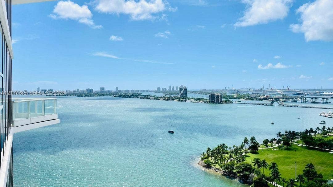 2020 N Bayshore Drive, #2102, Miami, FL 33137 Exterior balcony featuring floor-to-ceiling glass paneling and expansive water and urban skyline scenery