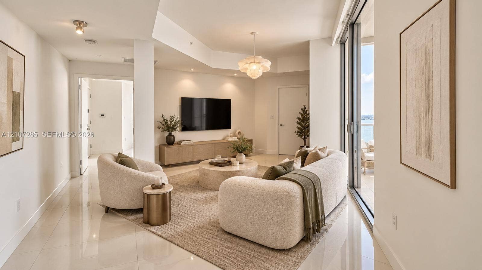 2020 N Bayshore Drive, #2102, Miami, FL 33137 Living area featuring polished tile flooring, recessed ceiling lighting, a decorative pendant fixture, and expansive sliding glass doors ( AI used for interiors )