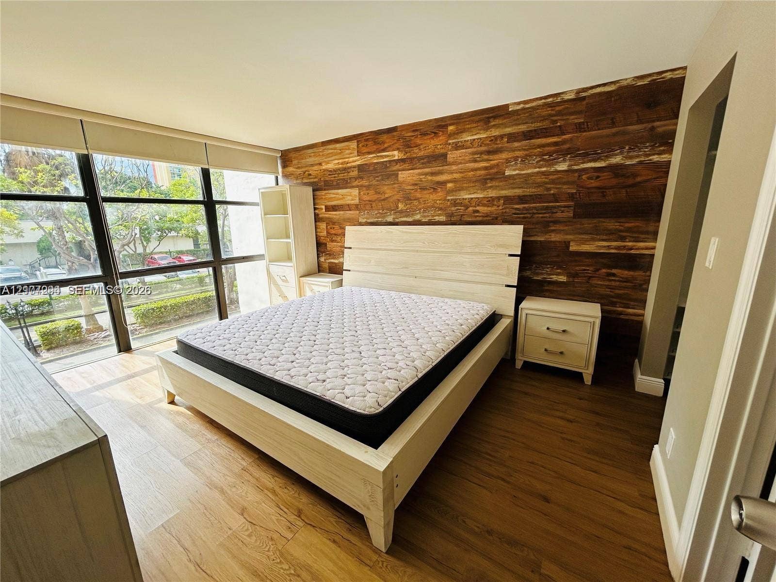 17021 N Bay Road, #219, Sunny Isles Beach, Sunny Isles Beach, FL 33160 Floor-to-ceiling windows, wood-finish wall paneling, and wood-finish flooring