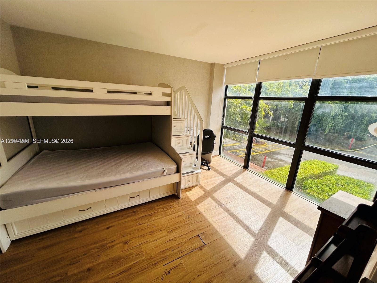 17021 N Bay Road, #219, Sunny Isles Beach, Sunny Isles Beach, FL 33160 Floor-to-ceiling windows featuring black grid frames and wood-finish flooring