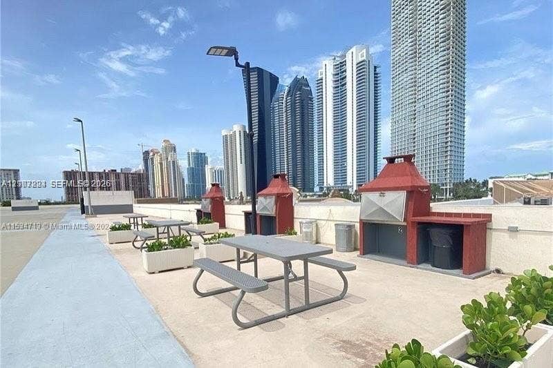 17021 N Bay Road, #219, Sunny Isles Beach, Sunny Isles Beach, FL 33160 Outdoor terrace featuring built-in masonry grilling stations and integrated concrete planters