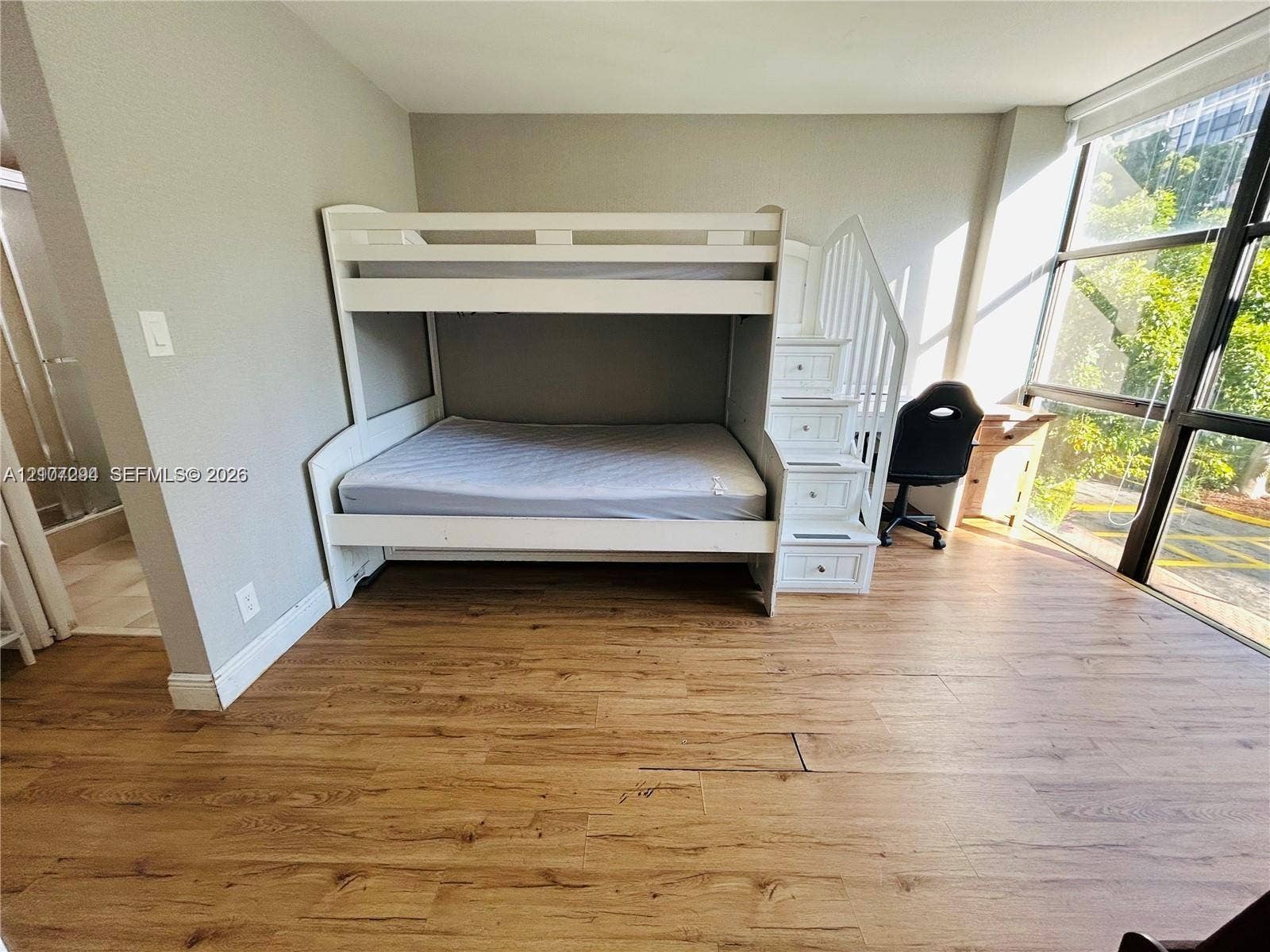17021 N Bay Road, #219, Sunny Isles Beach, Sunny Isles Beach, FL 33160 Floor-to-ceiling windows with black metal framing and wood-finish flooring