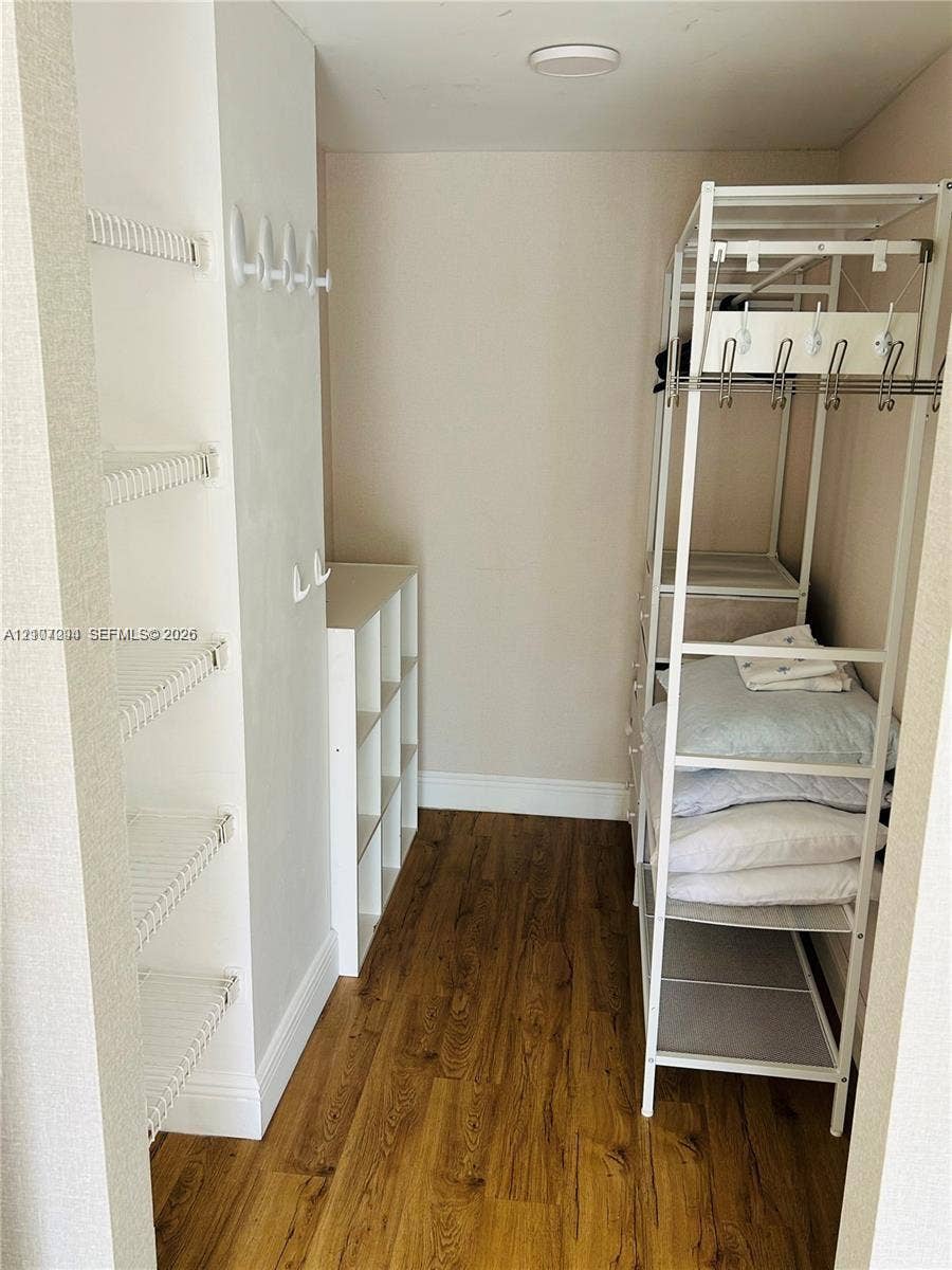 17021 N Bay Road, #219, Sunny Isles Beach, Sunny Isles Beach, FL 33160 Storage space featuring wood-finish flooring, white wire wall shelving, integrated wall-mounted hooks, and a white laminate cubby unit