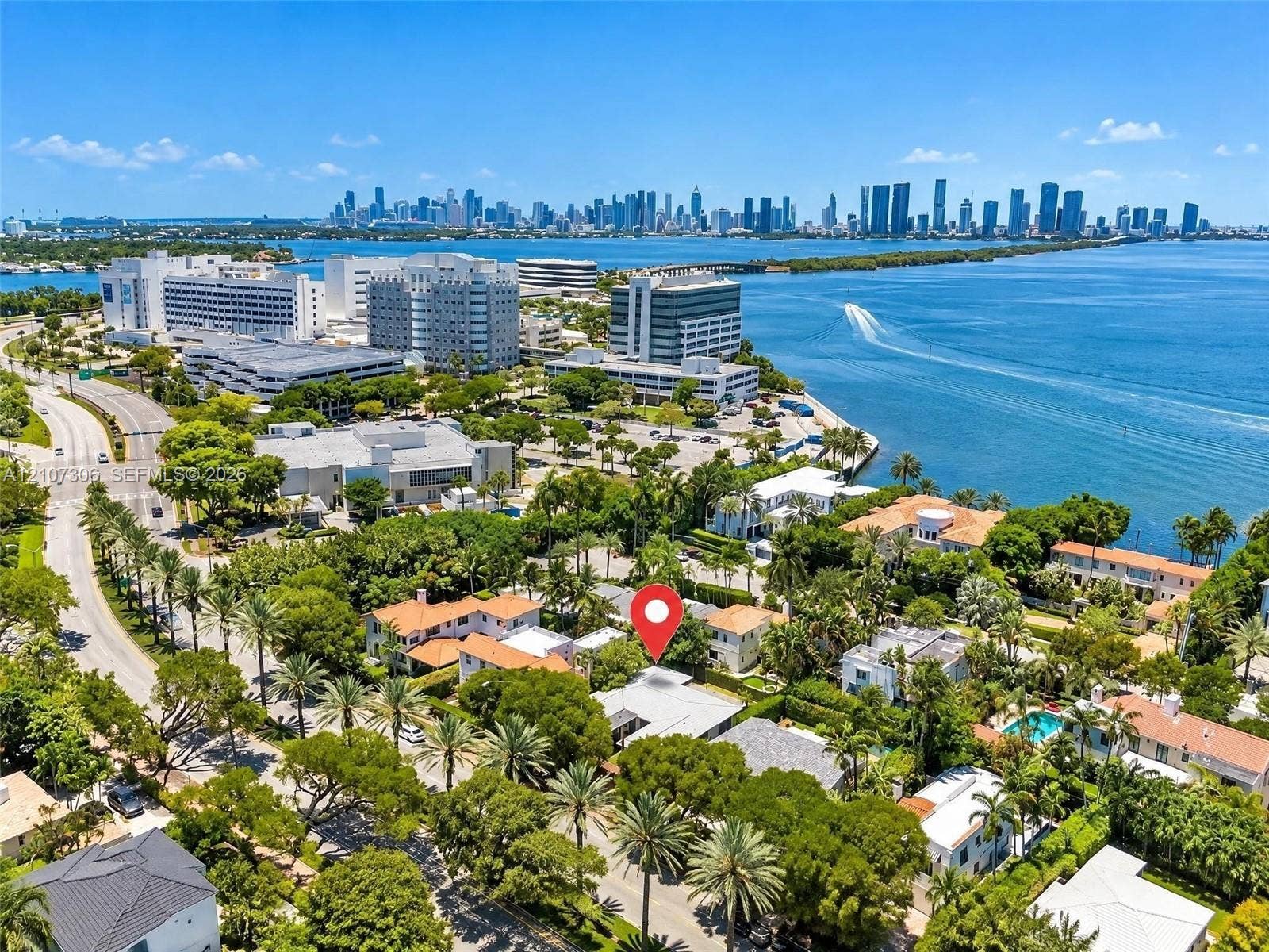 4322 Alton Road, Miami Beach, FL 33140 Aerial perspective featuring mature coastal landscaping, proximity to the bay, and a cityscape backdrop