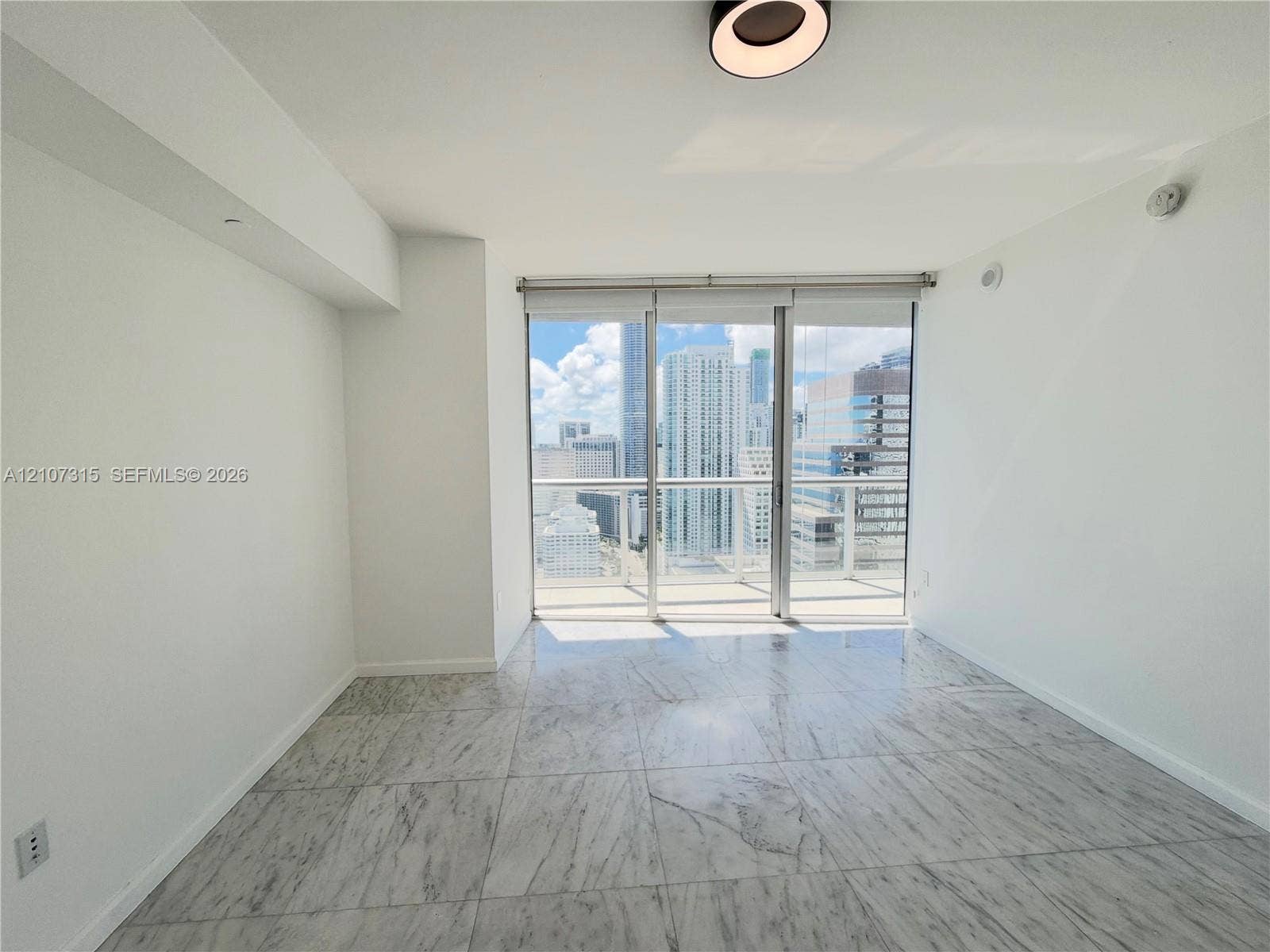 495 Brickell Avenue, #3803, Miami, FL 33131 Floor-to-ceiling sliding glass doors, stone tile flooring, neutral wall finish, and modern recessed lighting
