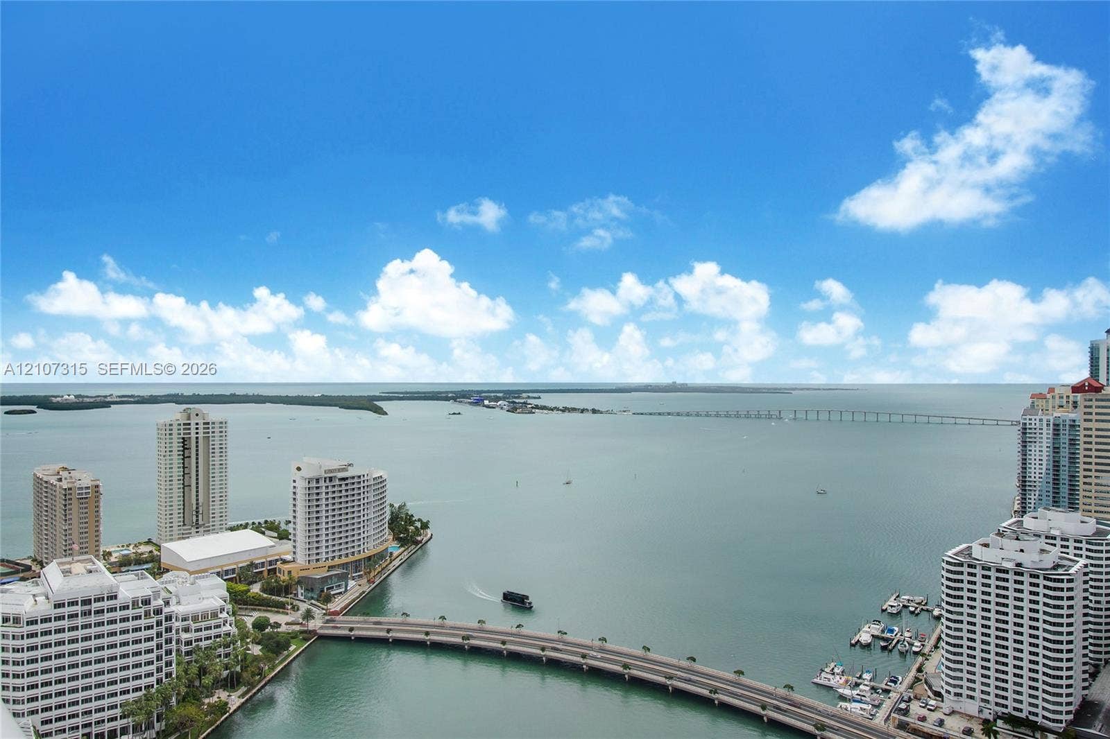 495 Brickell Avenue, #3803, Miami, FL 33131 High-rise perspective featuring panoramic open water surroundings, structural bridge elements, and marina-style boat docking