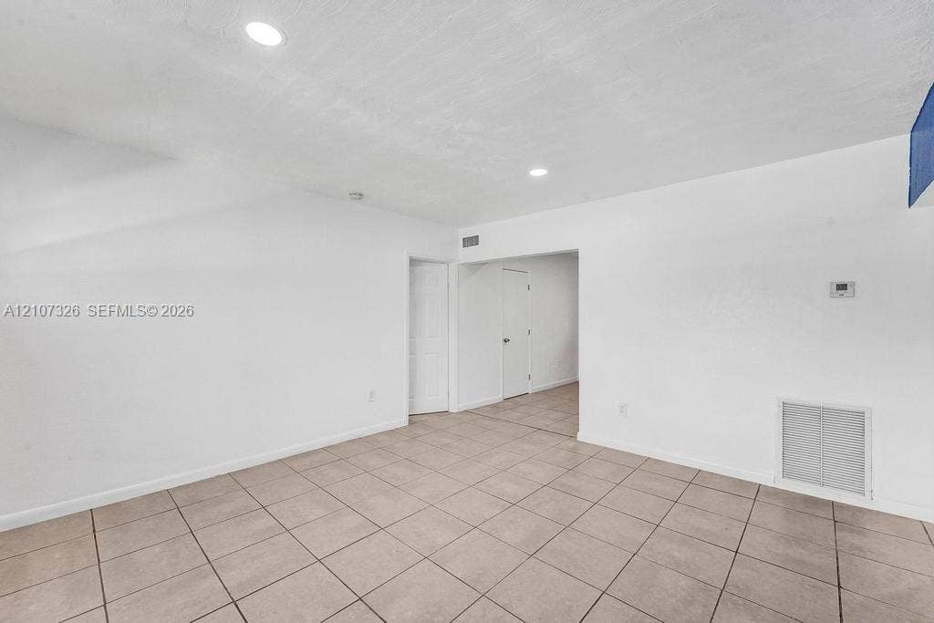 1801 NE 154th Street, #0, North Miami Beach, North Miami Beach, FL 33162 Neutral-toned tile flooring, recessed ceiling lighting, and crisp white wall finishes