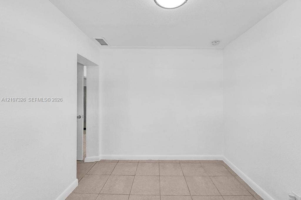 1801 NE 154th Street, #0, North Miami Beach, North Miami Beach, FL 33162 Neutral interior space featuring smooth wall finishes and large-format tile flooring