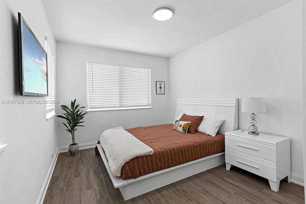 830 9th Street, #14, Miami Beach, Miami Beach, FL 33139 Room featuring wood-finish flooring, dual windows with horizontal blinds, and a flush-mount ceiling light fixture