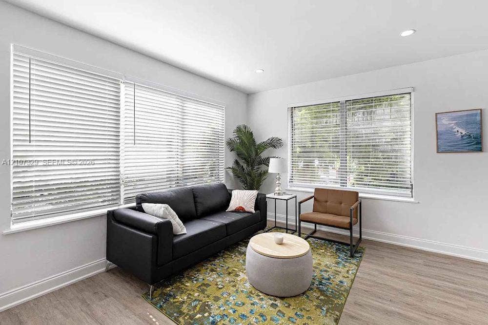 830 9th Street, #14, Miami Beach, Miami Beach, FL 33139 Living area featuring wood-finish flooring, recessed lighting, and expansive windows fitted with horizontal blinds