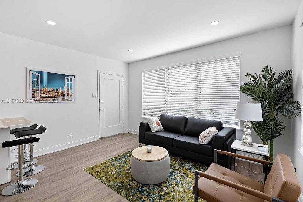 830 9th Street, #14, Miami Beach, Miami Beach, FL 33139 Living area featuring wood-finish flooring, recessed lighting, and large windows with horizontal blinds