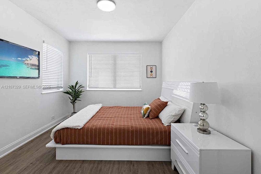 830 9th Street, #14, Miami Beach, Miami Beach, FL 33139 Room featuring wood-finish flooring, dual windows with horizontal blinds, and a neutral color palette